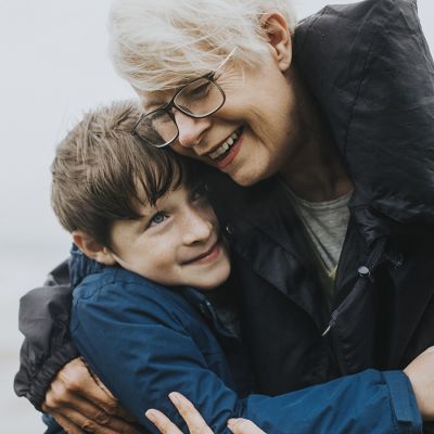 Happy grandmother hugging her grandson