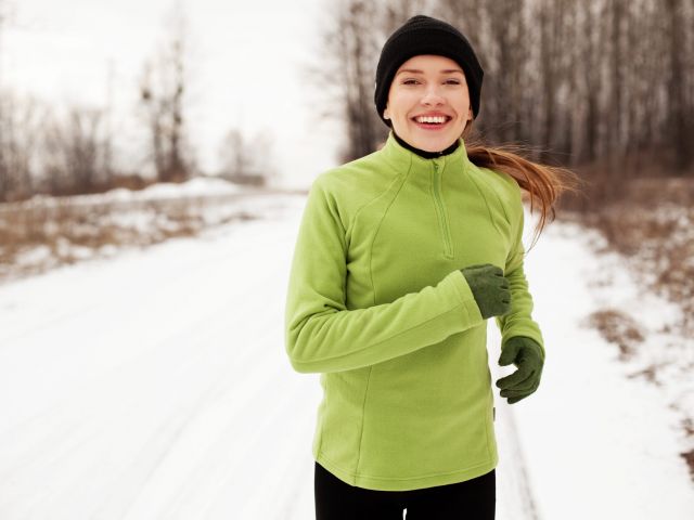 Happy woman running in winter