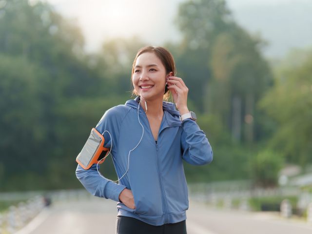 Healthy Asian woman is jogging outdoor. Fitness girl running. Female exercising at outdoor park.